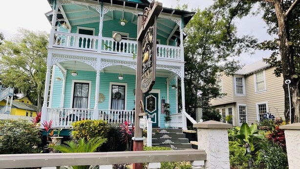 A two-story house with a balcony and a porch. - Peace & Plenty Inn Bed & Breakfast (St. Augustine)