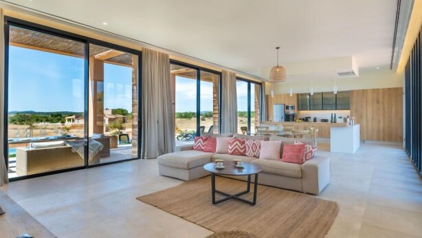 A spacious living area with a sofa, coffee table, and a view of the outdoors. - Can Navarro by Interhome (Inca)