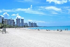 A beach with buildings in the background.