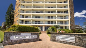 A multi-story building with a sign reading "beachpoint" at the entrance. - Beachpoint Unit 503 (Forster)