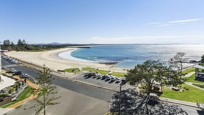 A coastal hotel with a parking lot, beach access, and a view of the ocean. - Beachpoint Unit 503 (Forster)