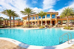 A hotel with a swimming pool, palm trees, and outdoor seating areas. - Charming Home With Private Balcony, 4 Miles From Disney! CDC Standards #4ro785 (Kissimmee)
