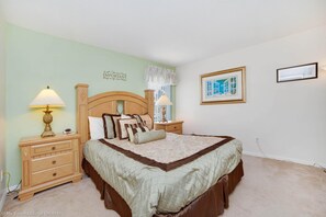 A bedroom with a bed, nightstands, a lamp, a framed picture, and a wall quote. - Lovely Lake Front Pool Home With CDC Cleaning Standards, Game Room #5hl252 (Davenport)