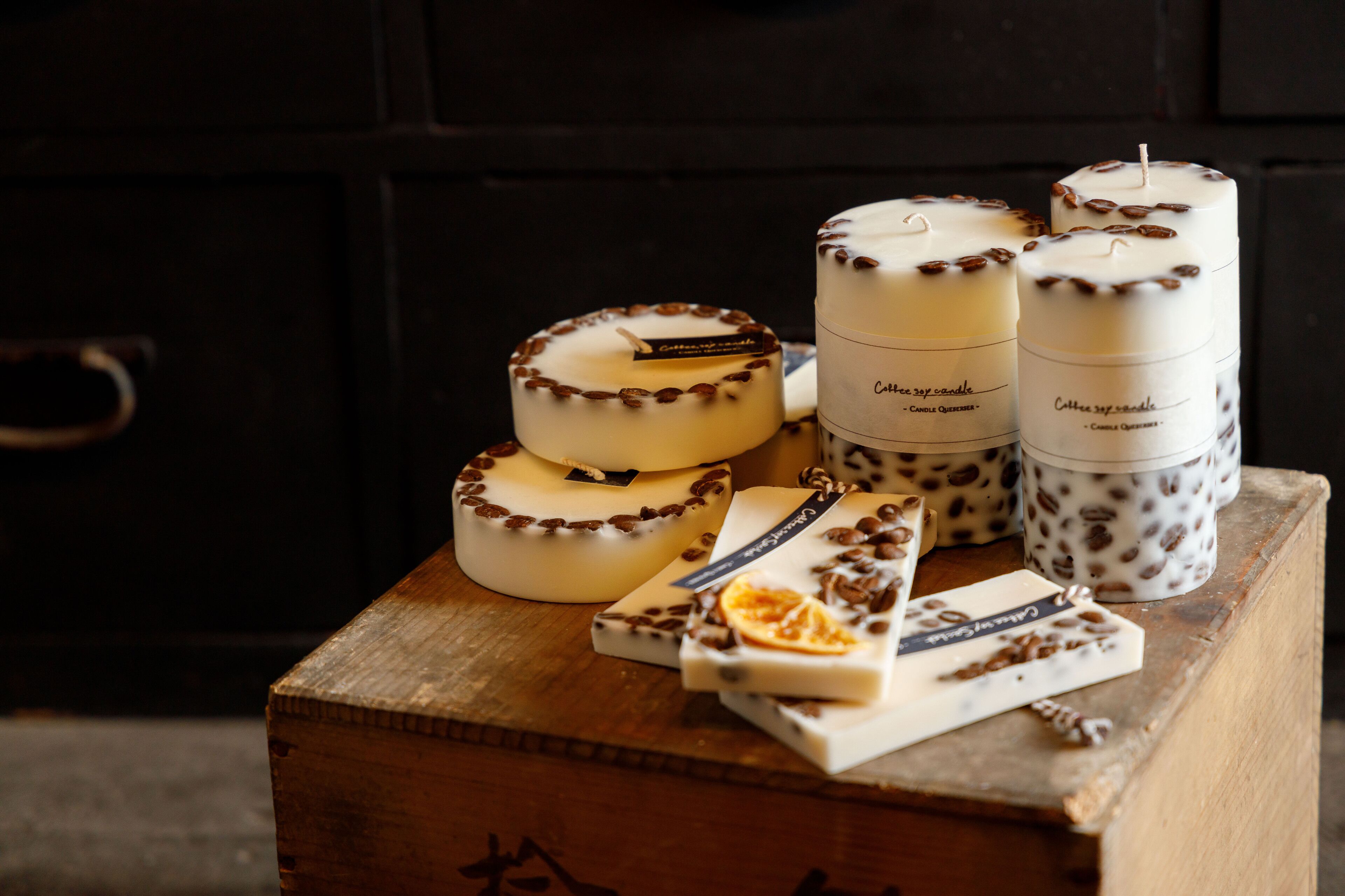 A wooden box with candles and chocolate bars.