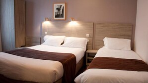 A hotel room with two beds, each with a wooden headboard, a nightstand, and a framed picture on the wall. - Hotel Cosmos (Paris)