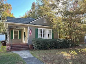 Welcome to this charming home with a cozy front porch, entryway, and beautifully manicured lawn.