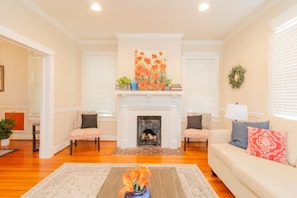 Cozy living room with a fireplace, armchairs, and a sofa, perfect for relaxing.