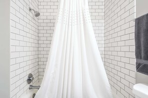 A shower with white tiled walls and a white curtain. - Walk to Nightlife & Attractions (Indianapolis)