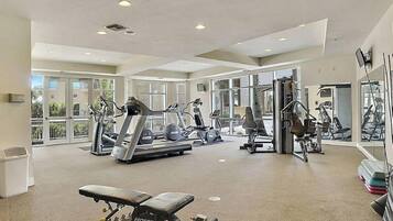 A gym with treadmills, elliptical machines, and weightlifting equipment.