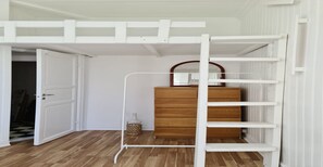 A room with a bunk bed, a wooden dresser, and a white ladder. - Oslo International Designers Space (Oslo)