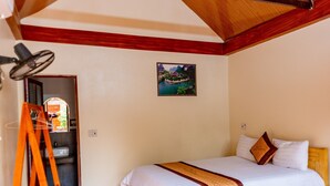 A bedroom with a wooden ceiling, a bed with white bedding, a wooden ladder, and a painting on the wall. - Tam Coc Melody Homestay (Nam Hoa Lu)