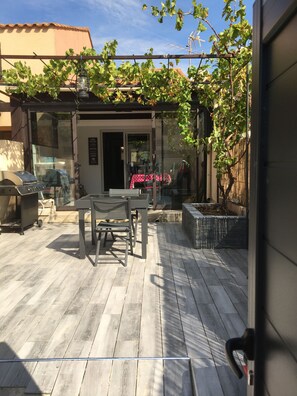 Enjoy dining and socializing on the outdoor patio with a grill and garden views.