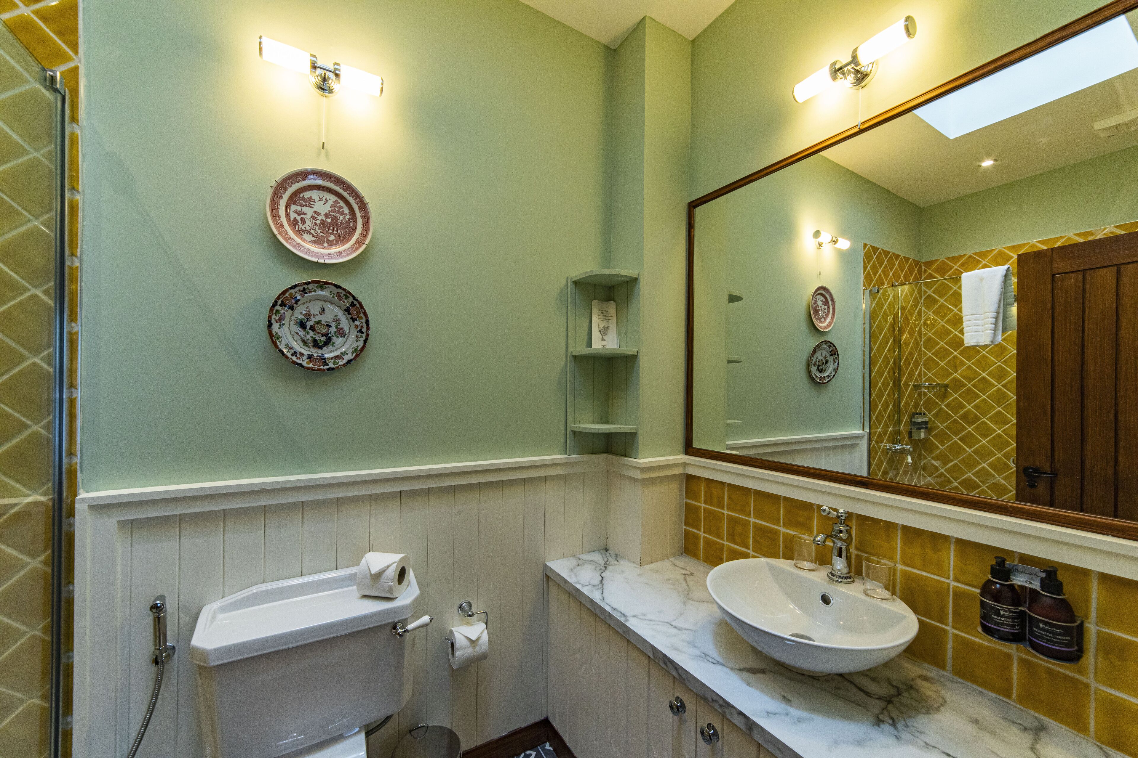A bathroom with a white sink, a mirror, and a shower.