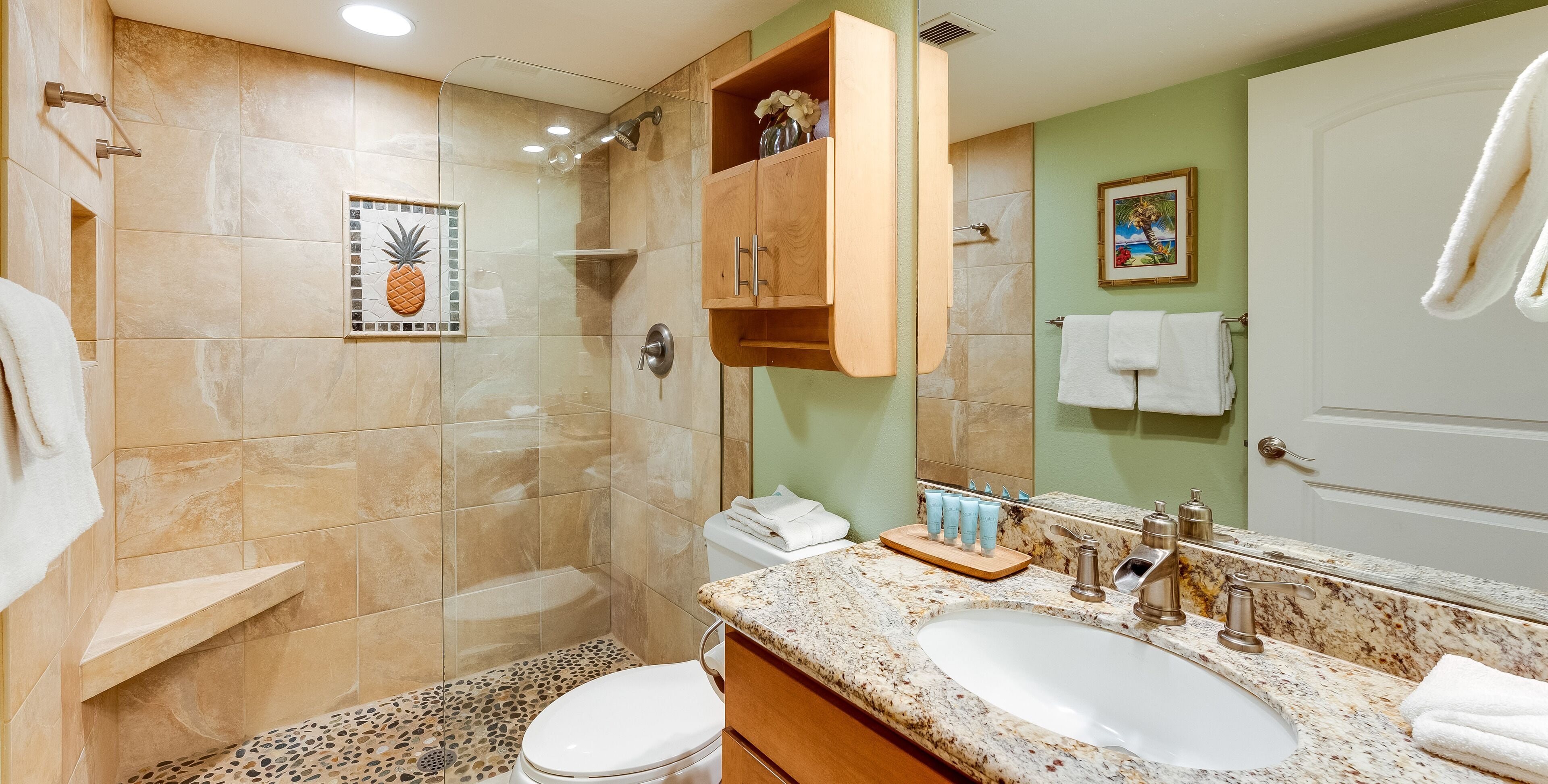 A bathroom with a shower, toilet, and sink.