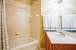 Combined shower/bathtub, towels, soap, toilet paper