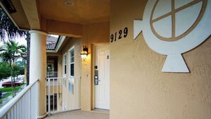 A hotel entrance with a balcony, a number sign '9129', and a door labeled 'B'.