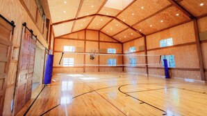 A spacious indoor gymnasium with wooden walls and a high ceiling. - Indoor Gymnasium, Seasonal Pool, 7 Bedroom, Sleeps 28 (Fort recovery)