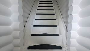 A staircase with white walls and black steps leading to a door at the top. - Stunning terraced Logcabin House with pool  (Saint Martin)