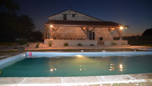 A rustic building with a pool in front, featuring a simple, open porch and a small garden area. - Large house 230m², 16 pers, private heated pool, 6000m² in the countryside (Nojals-et-Clotte)
