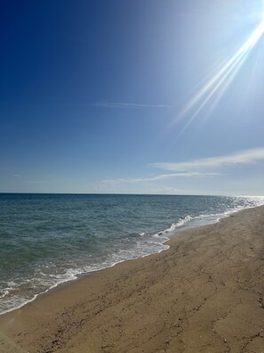 On the beach, sun loungers, beach towels