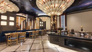 A luxurious hotel lobby with a central seating area, a reception desk, and a decorative ceiling. - Hotel Sepal (Bathinda)