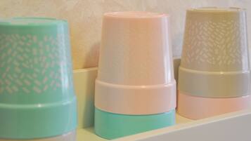 Three stacked containers with textured patterns on a shelf.