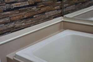 Shower, hair dryer, slippers, towels