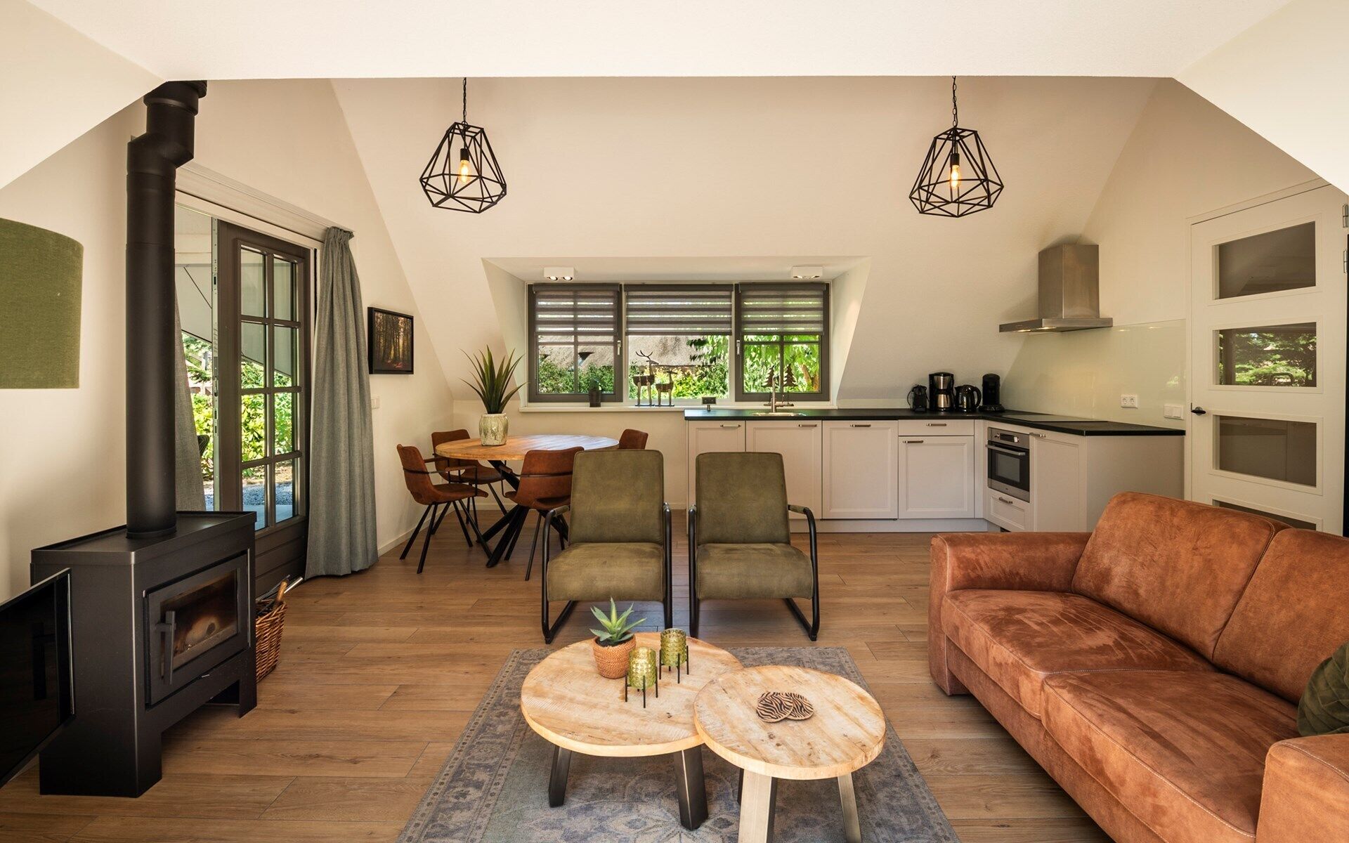A modern loft with a kitchen, dining area, and living space.