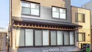 A hotel named 'hotel GOCO stay' with a 24-hour parking sign, a covered entrance, and a visible fire hydrant. - hotel GOCO stay Kyoto Shijo Kawaramachi (Kyoto)