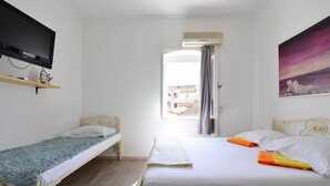 A room with two beds, a TV, and a painting. - Apartments Bulovic (Split)