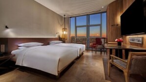 A hotel room with a large bed, a desk, and a TV. - Mumian Beijing Daxing International Airport, part of Hyatt (Daxing)
