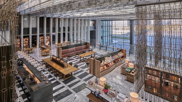 A spacious lobby with a checkered floor, seating areas, a bar, and a view of the city through large windows. - Mumian Beijing Daxing International Airport, part of Hyatt (Daxing)