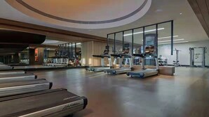 A modern gym with treadmills, stationary bikes, and weight machines. - Mumian Beijing Daxing International Airport, part of Hyatt (Daxing)