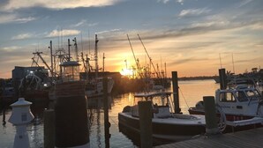 Un puerto deportivo con barcos amarrados a muelles de madera al atardecer.