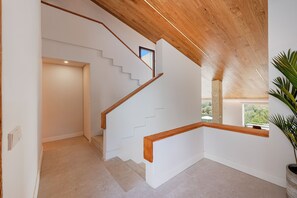 A staircase with wooden handrails and a white wall with a window. - Exclusive Casa Mir located in 'el Vila' with Pool & with all amenities (Puerto Pollensa)