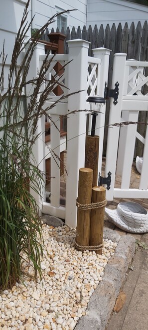 Stroll through the charming garden, surrounded by a white picket fence and lush greenery.