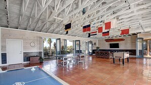 A spacious indoor area with a foosball table, a ping pong table, and a pool table. - Beach Access! Heated Community Pool! Float in the pool while looking at the beac (Port Aransas)