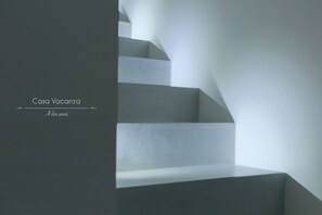 Stylish staircase leads to an upper level.
