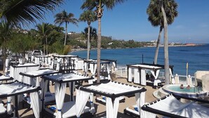 A beachside resort with outdoor seating and a pool area. - Our Happy Place (Puerto Plata)