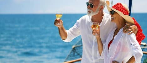 A couple on a boat with a clear view of the sea.