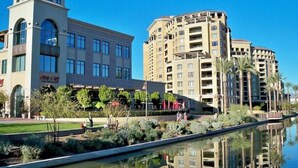A hotel with a modern architectural design, featuring a central courtyard with a water feature and surrounding greenery. - Scottsdale Oasis - Walk to Old Town & Fashion Square - Heated Pool (Scottsdale)