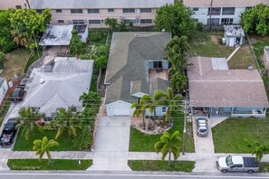 A residential area with multiple houses, a driveway, and a street. - Private Hot Tub, 3 Bdrm 3 Bath 1 Mi. To Beach (Lake Worth)