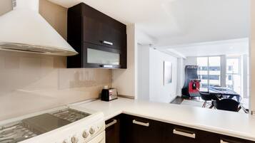 Departamento Deluxe | Cocina privada | Refrigerador con congelador, microondas, horno y parrilla de estufa