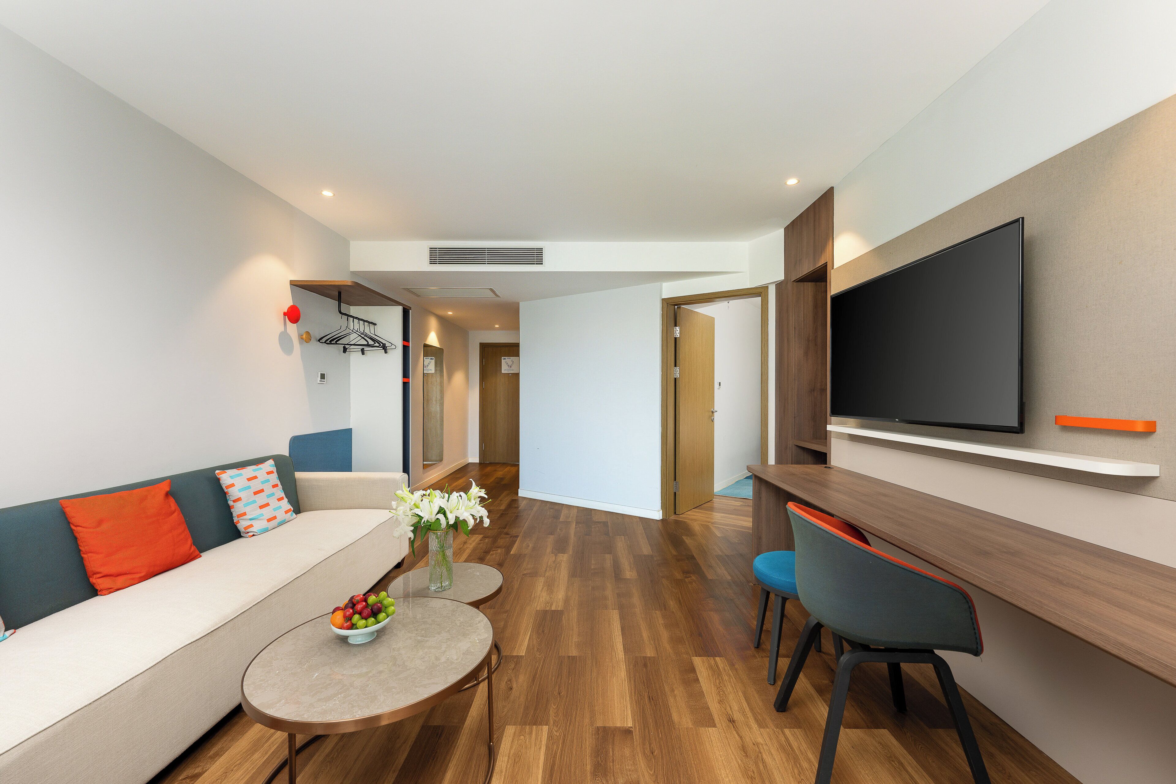 A modern living room with a sofa, coffee table, and TV.