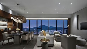 A modern living room with a city view, a dining area, and a kitchen. - Intercontinental Dongguan by IHG (Dongguan)