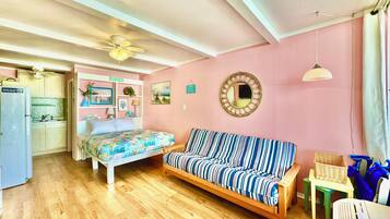 Cozy living space with a kitchenette, bed, and sofa, perfect for a comfortable stay.