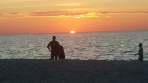 A beach scene with a sunset over the ocean. - Hotel Studio (Ground Level) - Unit C (Nokomis)