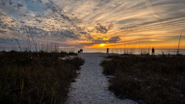 A beach path leading to the ocean with a sunset in the background. - Hotel Studio (Ground Level) - Unit C (Nokomis)