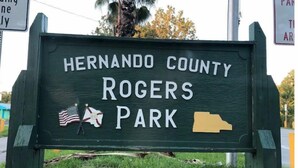 A sign for Hernando County Rogers Park with a map of the park and two flags. - The Mermaid Beach House 2 (Hernando Beach)