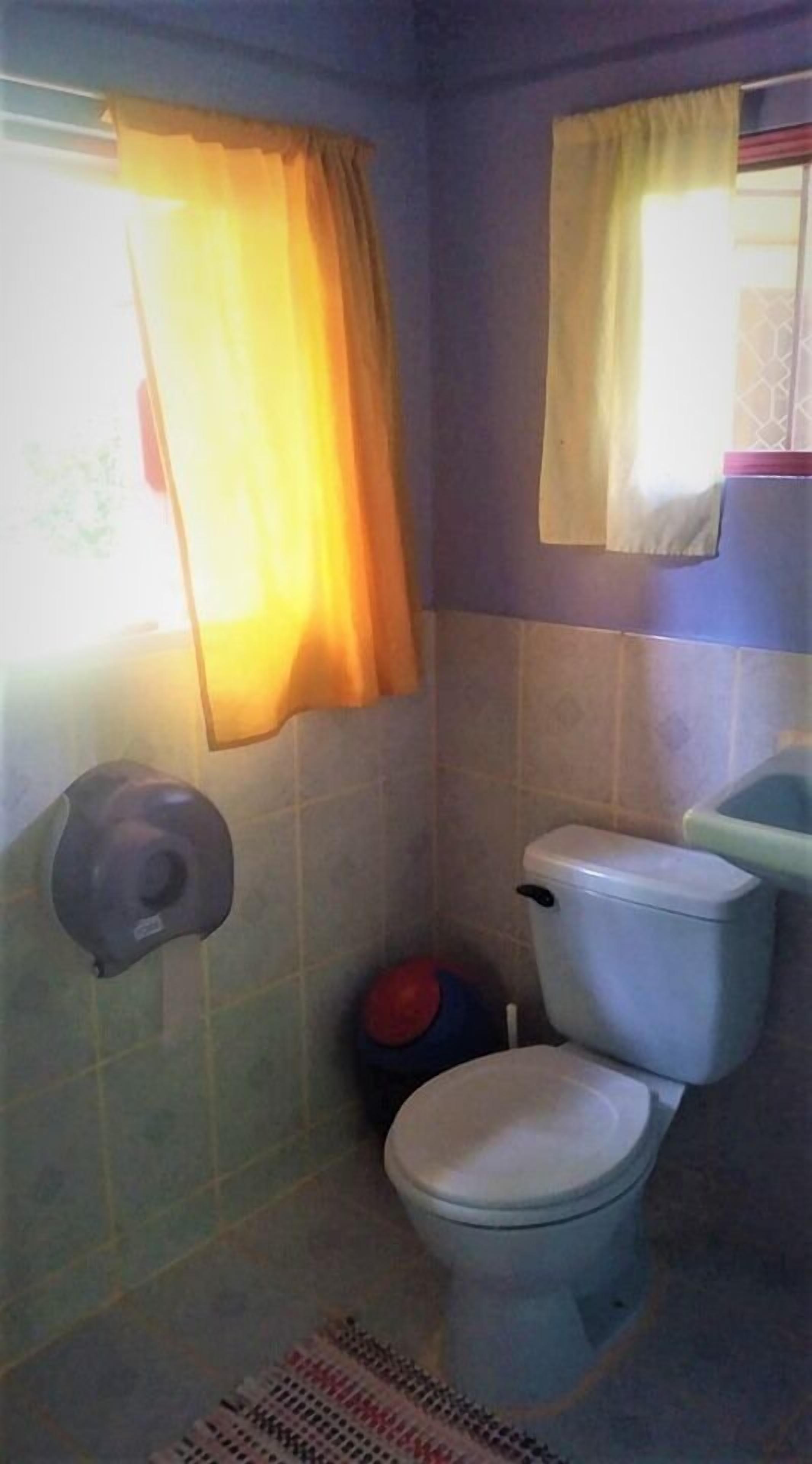 A small bathroom with a toilet, a bidet, and a shower area.